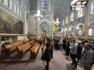 A class from the University of Notre Dame studies the Polish Worker Mural.